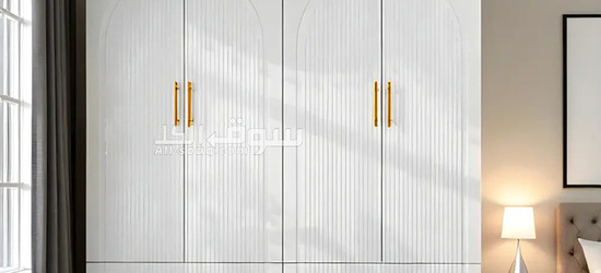 Elegant White 4-Door Wardrobe with Ribbed Detailing and Gold Handles